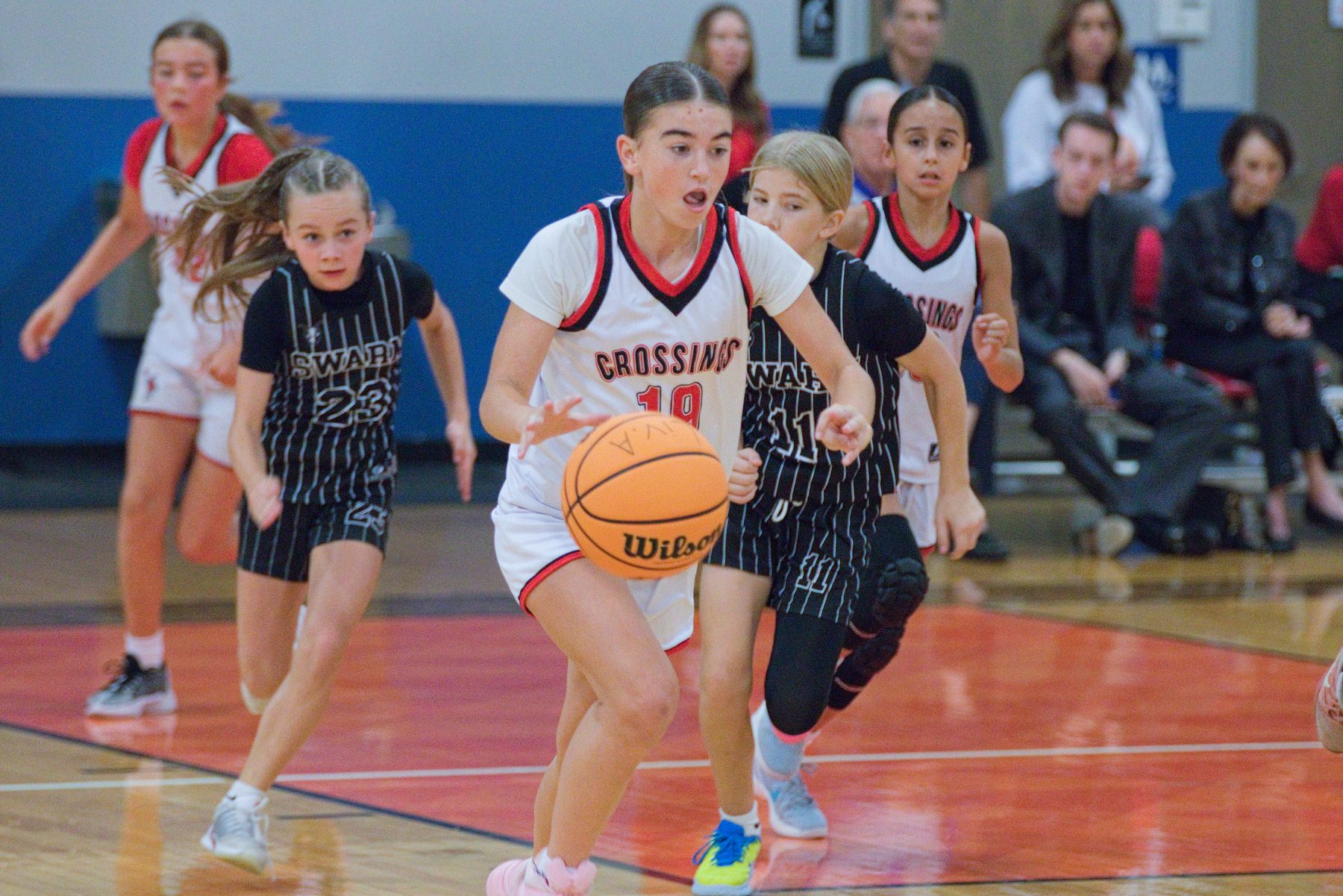 Basketball player pushing the ball in transition on a fast break