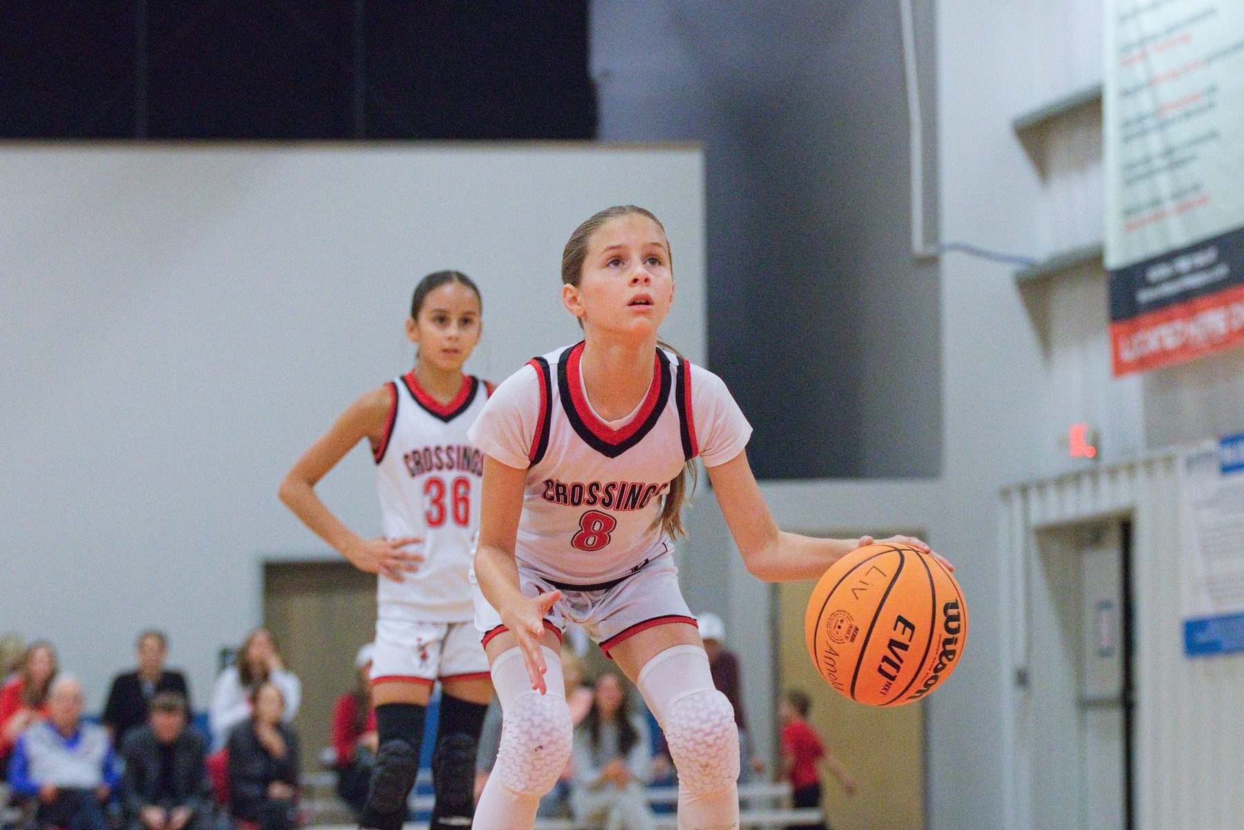 Basketball player settling into her stance at the start of a free throw