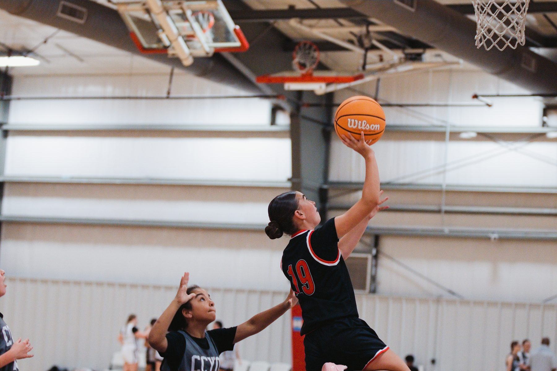 Basketball player going up for a layup under the basket